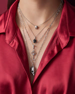 woman in red shirt wearing silver necklaces