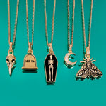 5 gold necklaces on green background