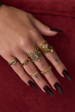 Woman wearing gold skull rings