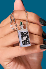 Hand holding Universe Necklace